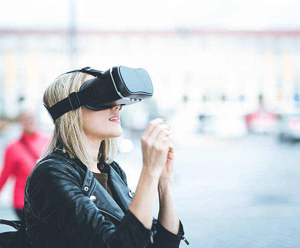 istock Women testing Virtual Reality simulator on the street 623784688