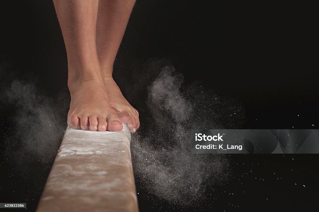 Balance Beam Action image of feet on balance beam Gymnastics Stock Photo