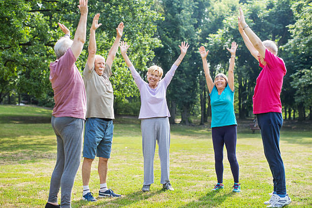 istock Laughter club practises laughing at a park 623825282