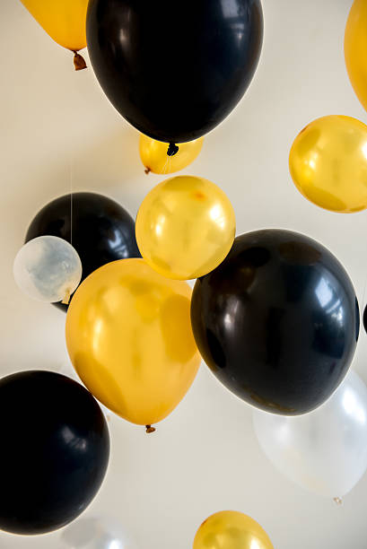 istock balloons yellow and black color on backdrop 623826620
