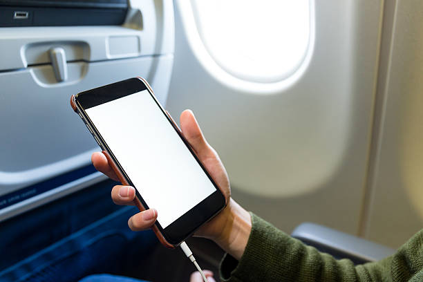 istock Woman holding a smart phone on airplane 623826646