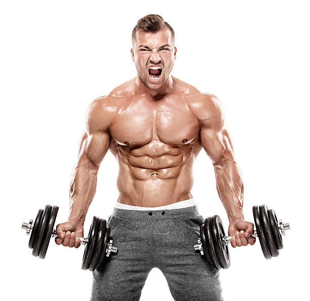 Muscular bodybuilder guy doing exercises with dumbbell stock photo