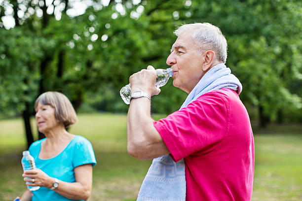 istock Healthy senior man taking break from exercise in park 623827768