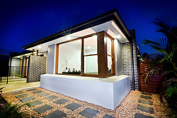 istock Mansion front side illuminated at night with a gravel garden 623828218