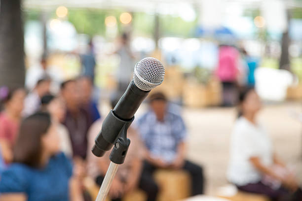 istock close up microphone in outdoor event with people background. 623828762