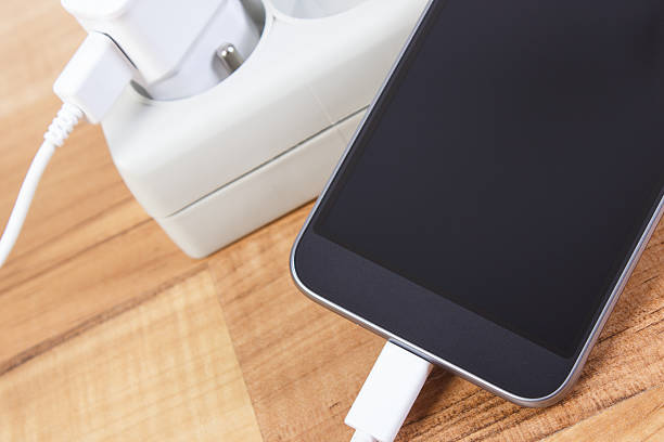 istock Mobile phone with connected plug of charger, smartphone charging 623847838