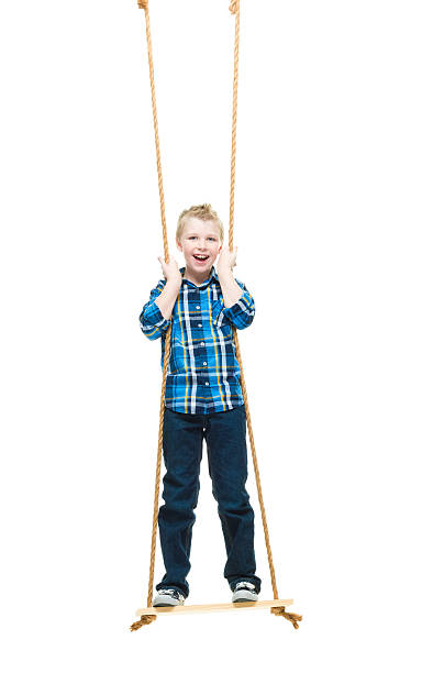istock Smiling little boy swinging 623847894