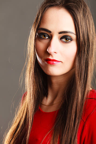 istock woman long straight hair dark makeup red lips on gray 623858310