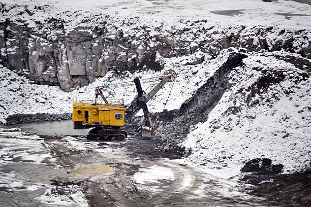 istock big huge yellow excavator in granite quarry winter 623858900