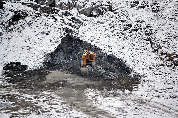 istock big huge yellow excavator in granite quarry winter 623858970