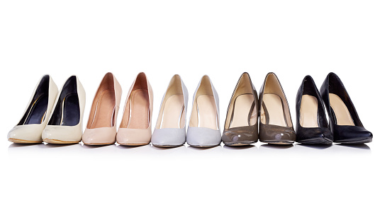 Shot of a selection of high heel shoes in a row isolated on white