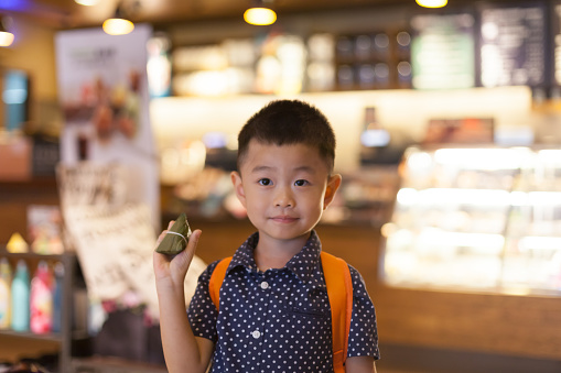 Asian cute child hold Chinese rice dumpling.