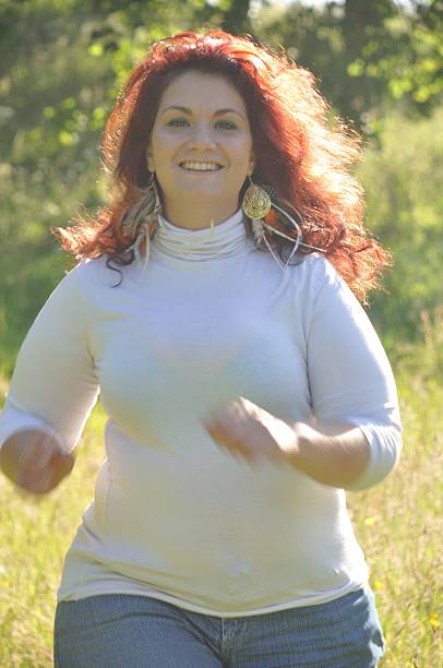 istock Woman running in a meadow 623864752