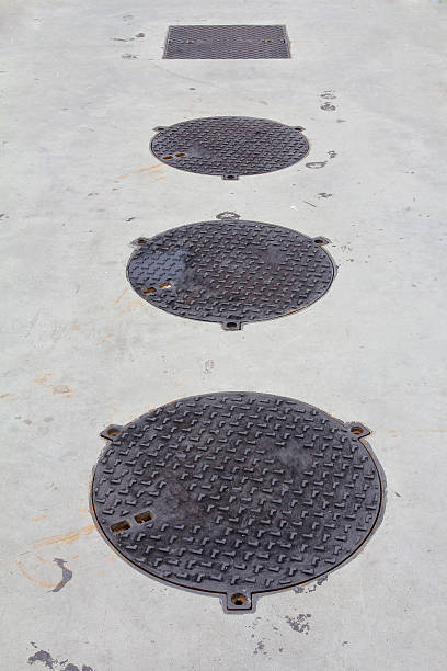 istock Metal drain lid or manhole cover on the concrete floor 623866448