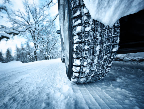istock Car tires on winter road 623866630