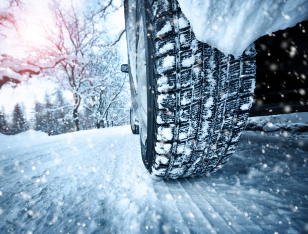 istock Car tires on winter road 623867096