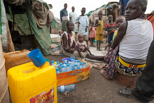 Juba, South Sudan - February 28th, 2012: Unidentified people prepare plastic containers to collect water in refugee camp, Juba, South Sudan, February 28, 2012.