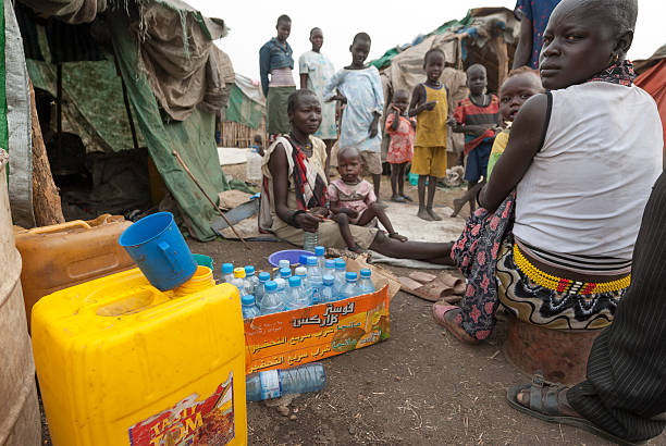 People prepare collect water in refugee camp, Juba, South Sudan. stock photo