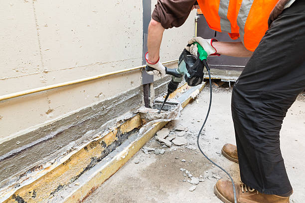istock Bricklayer, with professional pneumatic hammer, is demolishing a terrace 623868054