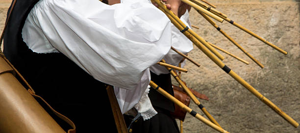 Detail of a group of musicians in traditional Sardinian costume while playing launeddas