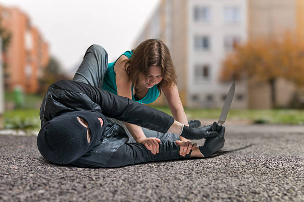 istock Woman fighting with armed thief with knife. Self defense concept. 623868162