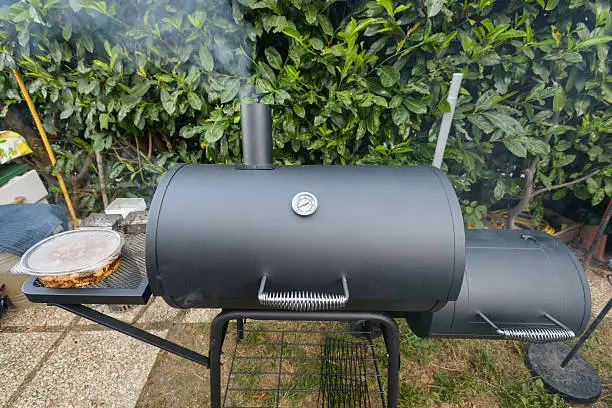 A black barbecue ready for grilling a slow cook pulled pork and ribs