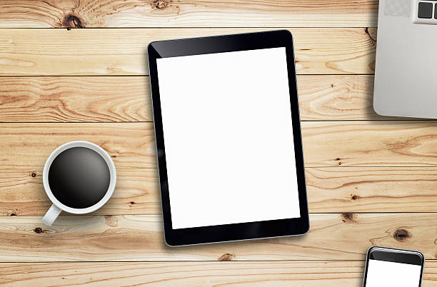 istock Tablet laptop coffee of cup and smartphone on wood table. 623879452