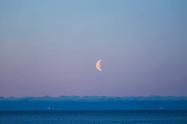 istock Half-moon over arctic ocean with clouds and floe 623879918