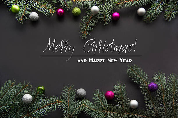 istock Christmas decoration composition from fir-tree branches on black with congratulation. 623880102