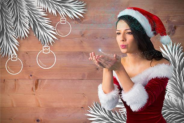 istock Beautiful woman in santa hat blowing snow 623880492