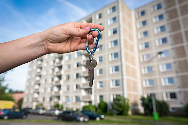 istock Real estate agent giving flat keys to a new owner 623885836