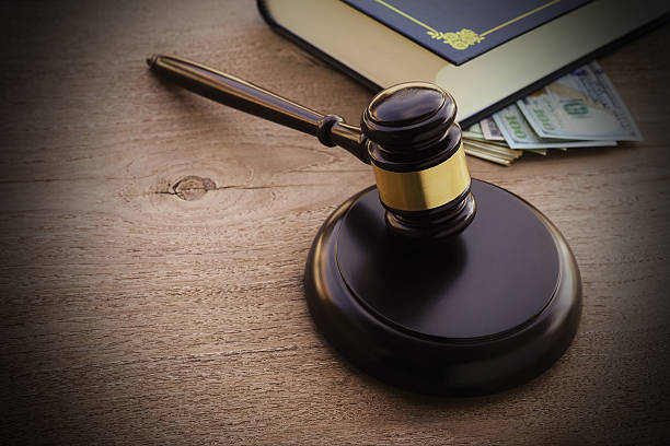 istock Hammers's judiciary with dollars on wooden background. 623887614