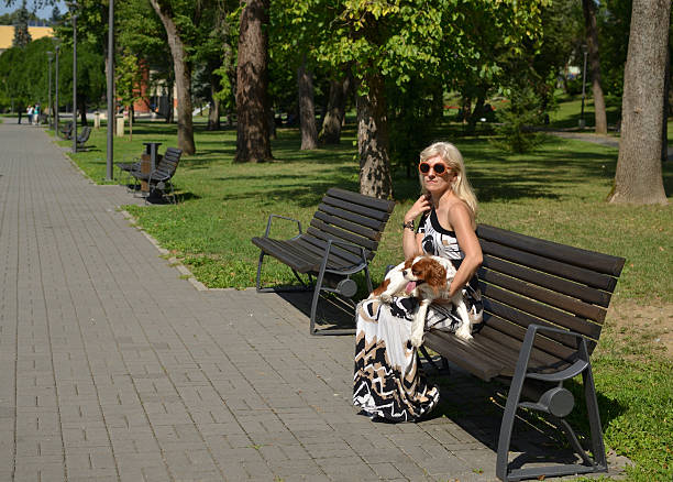 istock Woman Holding Her Dog on Bench 623887750