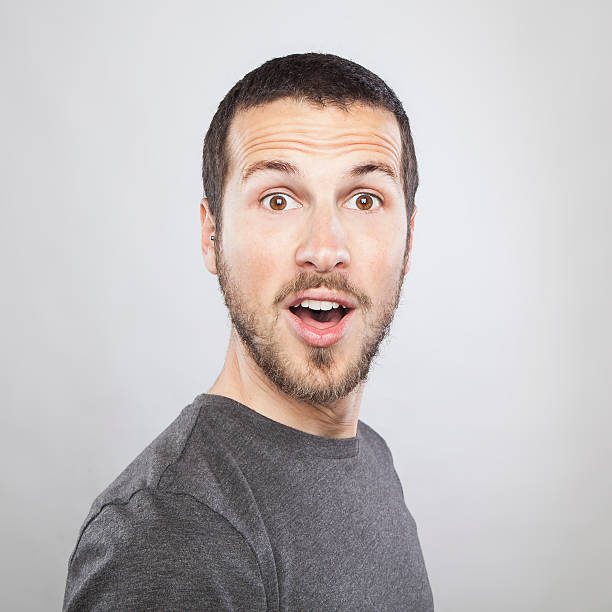 istock portrait of a young beautiful man surprised face expression 623887874