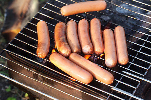 Sausages on the grill fire grate barbecue stock photo