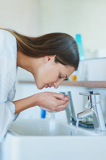 istock Waking up her skin with a splash of water 623888418