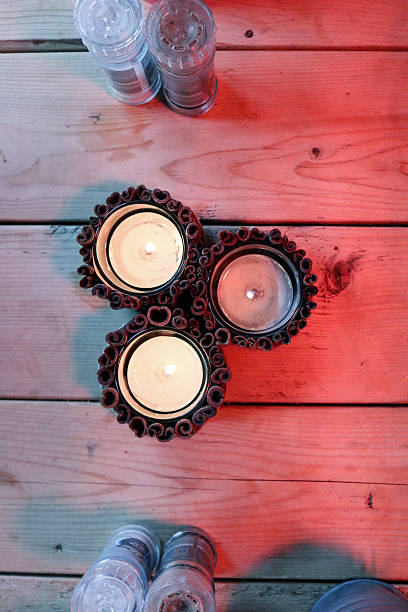 istock Three cinnamon candles on wooden table with condiments 623888848