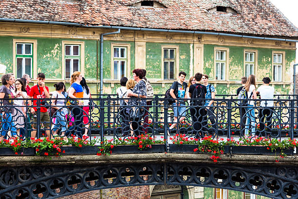 people walking across liar's bridge in sibiu, transylvania, romania - europe bridge editorial eastern europe imagens e fotografias de stock