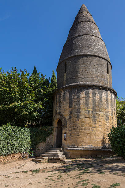 Sarlat, France - September 9, 2016: The medieval Lanterne-des-Morts in the town of Sarlat (Sarlat-La-Caneda) in the Dordogne area of the Nouvelle-Aquitaine region of France. Situated in the grounds of the Abbey of Saint-Sauveur of Sarlat.