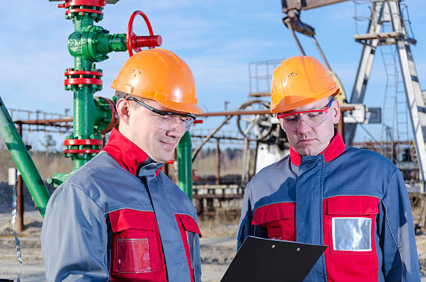 istock Two workers in the oilfield 623899076
