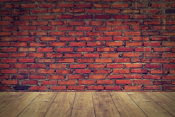 istock wood floor with old brick wall background. 623900440