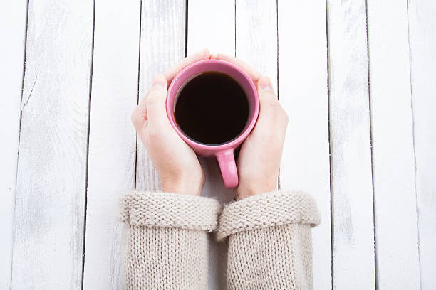 istock coffee mug in hand white vintage wooden background 623901138