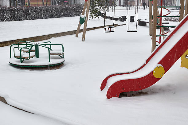 istock Children playground in winter snow covered snowfall. 623906222