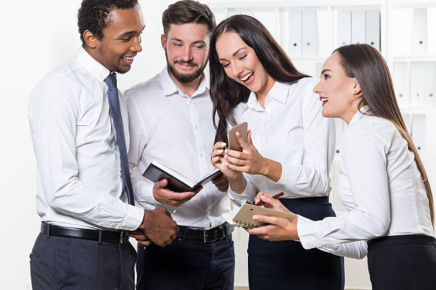 istock Group of office workers watching cat video 623909436