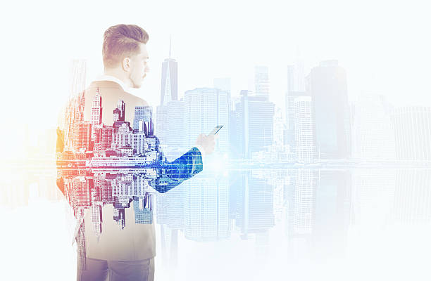 istock Businessman with mobile phone and large city 623911192