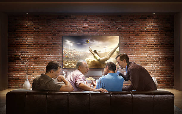 istock Adults watching Volleyball game at home 623912386