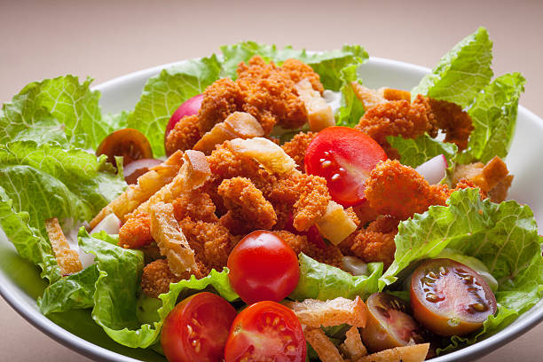 Schnitzel on fresh lettuce and tomato