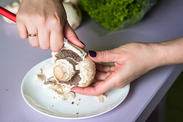 istock hands clean mushrooms with knife 623919056