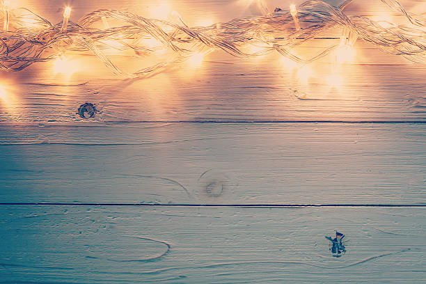 istock christmas light and christmas decoration on white wood 623919910