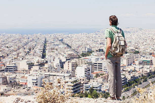 Young man looking on a big city, travel concept